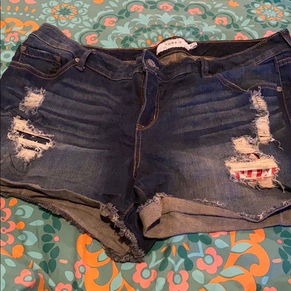 torrid Pants - Ripped jean shorts, with American flag patches.